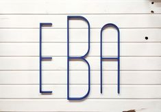 the letters b and f are made out of blue metal pipes on a white wall