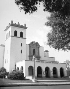 an old black and white photo of a building with a clock tower on the front