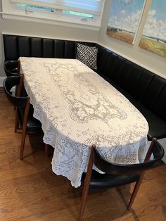 a white table cloth on top of a black bench