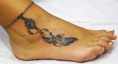 a woman's foot with a feather and beads tattoo on the side of it