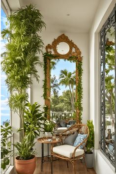 Cozy balcony with lush plants, a wicker chair, and a decorative mirror reflecting the greenery outside. Balcony Diy, Simple Budget