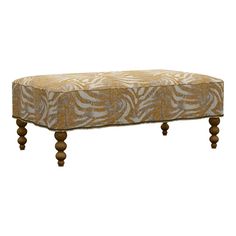 a bench with zebra print upholstered on the top and wooden legs, in front of a white background