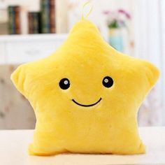 a yellow stuffed star sitting on top of a table