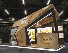 a booth designed to look like a house with wooden walls and roof, in an indoor area