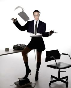 a man in a suit and tie sitting at a desk with an open laptop computer