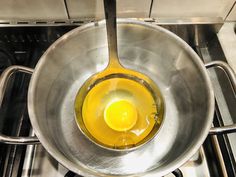 an egg is being cooked in a pan on the stove