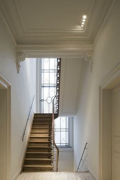 an empty room with stairs leading up to the second floor