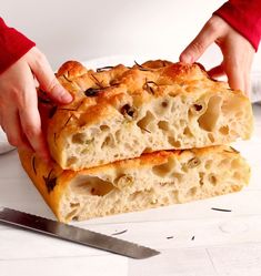 two pieces of bread being held by someone's hands over the top of it