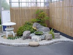 a small garden with rocks and plants in it