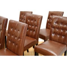 a set of six brown leather dining chairs