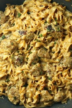 a skillet filled with pasta and meatballs