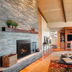 a living room filled with furniture and a fire place next to a wall mounted tv