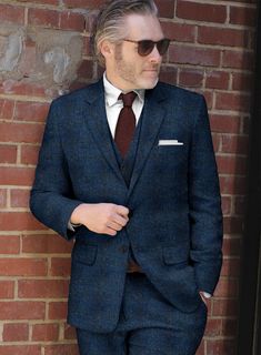 If you are in need of some classy outfit for winter to get a smart winter style, look no more further and grab our Harris Tweed Scot Blue Suit. Crafted from 100% wool, the super rich hue and feel of the suit can get you all the limelight wherever you go also it will hold a special place in the wardrobe of any sophisticated suit wearers.    Look Includes  Harris Tweed Scot Blue Fabric  Two Button Jacket Style  Notch Lapel  Horn Royal Black Buttons  Single Vent  Three Cuff Buttons  Two Welted Back Winter Tweed Three-piece Business Suit, Winter Tweed Three-piece Suit For Business, Winter Business Tweed Three-piece Suit, Winter Formal Tweed Three-piece Suit, Winter Semi-formal Tweed Three-piece Suit, Semi-formal Winter Tweed Three-piece Suit, Elegant Tweed Suits For Winter, Classic Wool Three-piece Suit For Winter, Wool Three-piece Suit With Welt Pockets For Winter