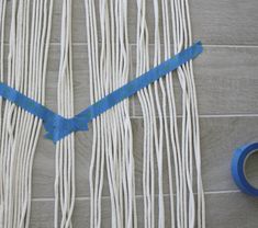 a piece of blue tape sitting on top of a table next to a pair of scissors