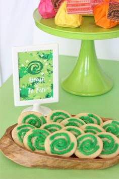 there is a plate of cookies on the table next to a sign that says happy st patrick's day