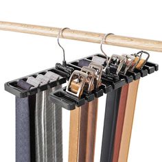 four pairs of belts hanging from a wooden rail with clips attached to them and two metal hooks on each side