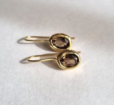 "These oval, Smokey quartz earrings were designed in a classic style to beautifully accompany you through your busy days. The classic simple design is always pretty for day and evening, work or fun. The gold brown earrings were carefully handmade from start to finish and are very elegant. Materials: The Smoky earrings were made in 14k gold plating and gold filled 14k wire, and can be also ordered in sterling silver.  The 14k gold earrings are also available in 9k OR 14k Solid gold. They can be o Brown Oval Earrings As A Gift, Brown Oval Earrings Gift, Brown Oval Earrings For Gift, Elegant Oval Brown Earrings, Brown Earrings, Earrings Classic, Oval Earrings, Oval Earring, Earrings Drop