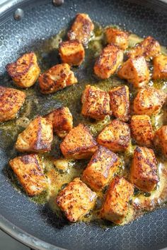 some food is cooking in a frying pan on the stove top and ready to be eaten