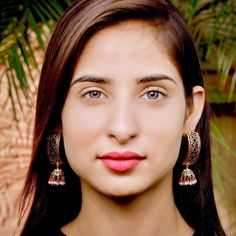 Traditional punjabi "dandi jhumki" in gold plated silver. The pearls are freshwater and the red and green stones are synthetic ruby,emerald look alikes.