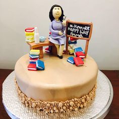 a cake decorated with an image of a woman sitting at a table and holding a chalkboard