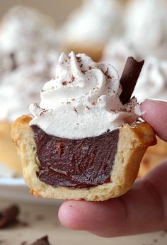 there is a pastry with whipped cream on top and chocolate shavings around it