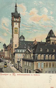 an old postcard with a clock tower in the middle and cars on the street below