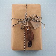 a wrapped present with a bird ornament on it