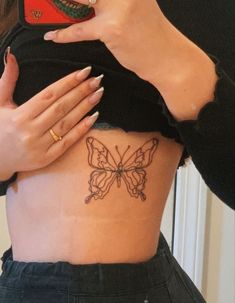 a woman with a butterfly tattoo on her stomach