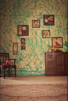 a room with green walls and pictures on the wall