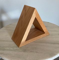 a wooden object sitting on top of a marble table