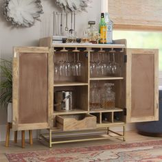 a wooden cabinet with wine glasses on it