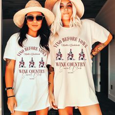 two women standing next to each other wearing matching shirts