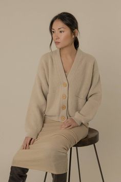 A soft and warm boxy cardigan Description Loose silhouette v-neck and chunky alpaca-wool blend cardigan in a pearl knit that accentuates the softness of the alpaca fibres. The piece is finished with ribbed trims and features two front patch pockets for practicality, and buttons made of natural wood to increase the natural raw feel of the cardigan. Composition 25% Alpaca 75% Superfine Wool. Wood buttons. Superfine Wool - The softest and finest wool produced, taken from a lamb's first shearing; Al Pearl Knit, Alpaca Cardigan, Brown Fits, Alpaca Fiber, Sustainable Brand, Alpaca Wool, Cardigan Tops, Wool Cardigan, Natural Wool