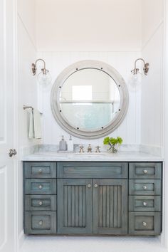 a bathroom with a large mirror above the sink