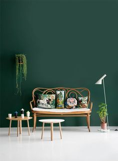 a room with green walls and furniture in it