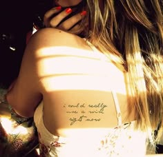 the back of a woman's shoulder with a tattoo saying, i am not really one