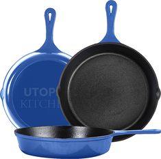 two blue pots and one black pan with the words utopia kitchen written on each side