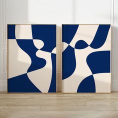 two blue and white abstract paintings on the wall in an empty room with hard wood flooring