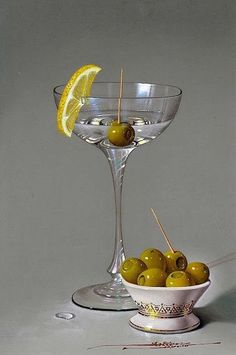 a painting of olives in a martini glass with lemon wedges on the rim