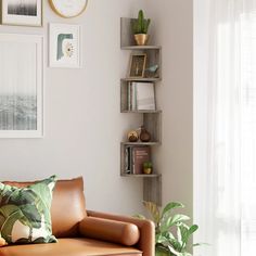 a living room filled with furniture and pictures on the wall