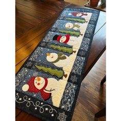 a table runner with snowmen on it