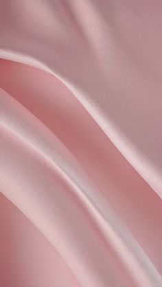 an image of pink silk fabric with smooth lines on it's surface, closeup