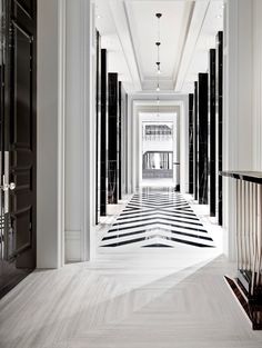 an elegant hallway with black and white striped floors