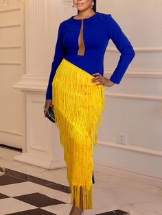 a woman in a blue top and yellow skirt