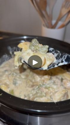 a ladle scooping some food out of a crock pot