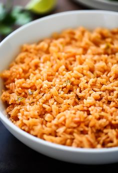 a white bowl filled with rice on top of a table