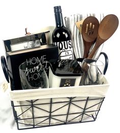 a basket filled with wine and kitchen utensils