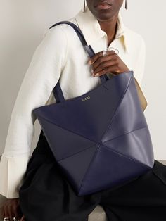 Bags have had a functional update this season - it's all about styles that can be converted so you can get maximum mileage. Loewe's medium 'Puzzle' tote has an origami-like construction that can be folded down when you're storing it or traveling. The leather is smooth and slouchy and the suede lining exquisitely soft. Chic Blue Calf Leather Bag, Loewe Puzzle, Large Leather Tote Bag, Perfume Design, Large Leather Tote, Raffia Bag, Classic Bags, Orange Bag, Tote Bag Leather