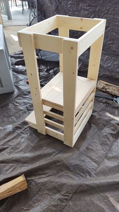 a wooden chair sitting on top of a tarp