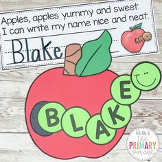 an apple with the word bake written in green and red on it, sitting next to a piece of paper that says apples, apples, yummy and sweet i can write my name